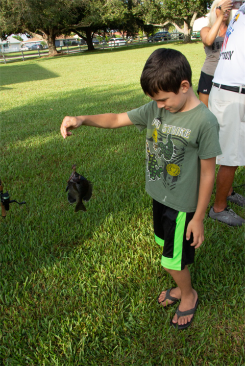 Fishing Clinic participant holding fish