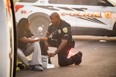 Officer helping crash victim