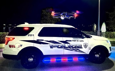 Drone flying above police vehicle